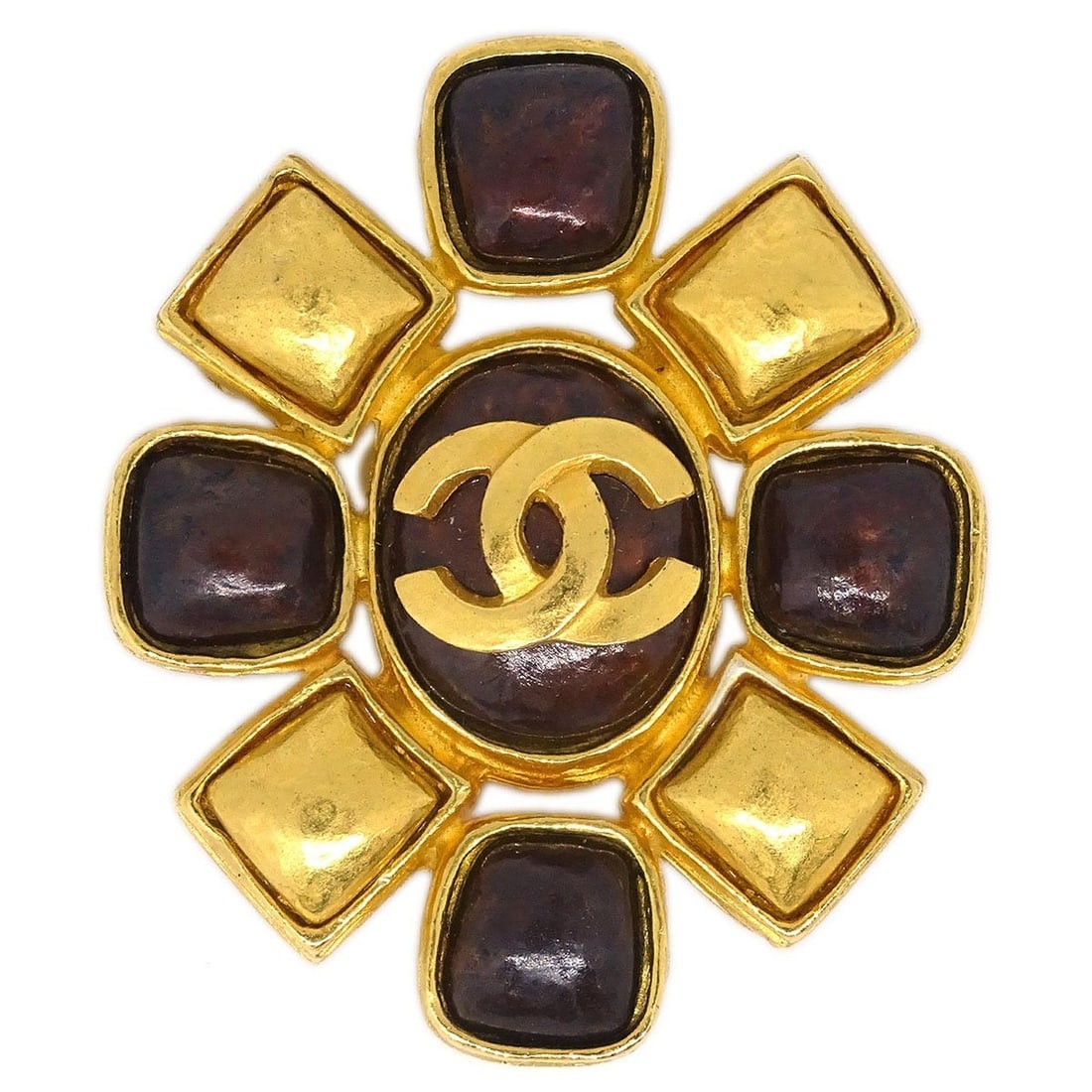 Gold Plated Chanel 97A Brooch Pin in Brown: Gold Plated Chanel 97A Brooch Pin in Brown This Chanel brooch features a gold-plated design with a brown accent, offering an elegant accessory for any ensemble. Crafted in France, it showcases the bra