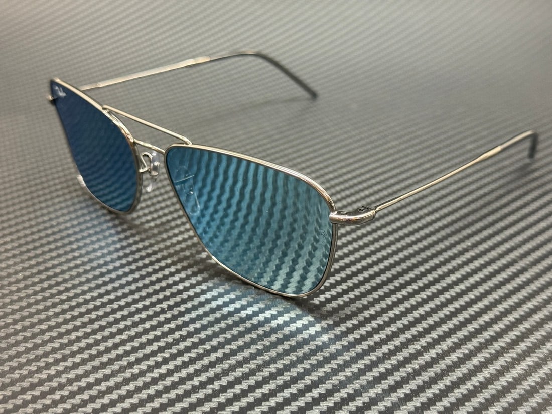 Ray-Ban RBR0102S Gunmetal Blue Mirror Unisex Sunglasses: Ray-Ban RBR0102S Gunmetal Blue Mirror Unisex Sunglasses Discover the stylish RAY BAN RBR0102S 004 GA sunglasses, featuring a sleek gunmetal frame paired with striking blue mirror lenses. This unisex d