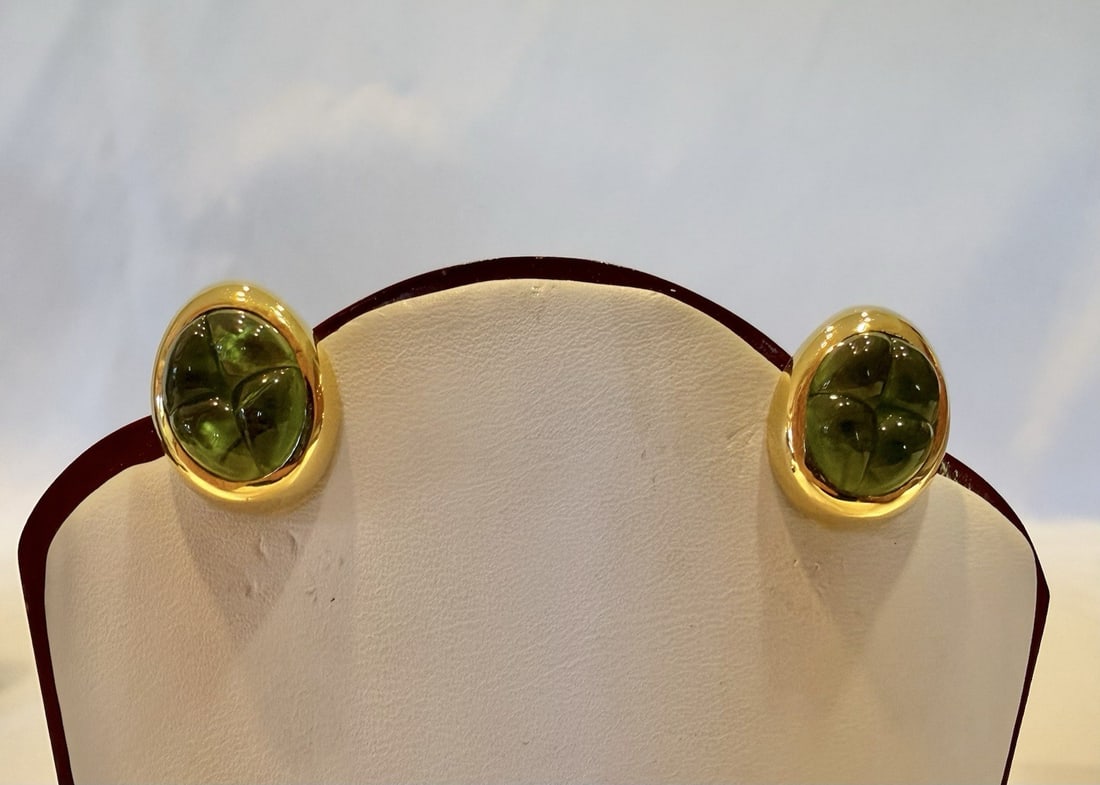 Pair of 18k Yellow Gold Peridot Earrings by Pomellato with Original Boxes: Pair of 18k Yellow Gold Peridot Earrings by Pomellato with Original Boxes This elegant pair of Pomellato earrings is crafted from 18k yellow gold and features peridot gemstones. The cuff stud design d