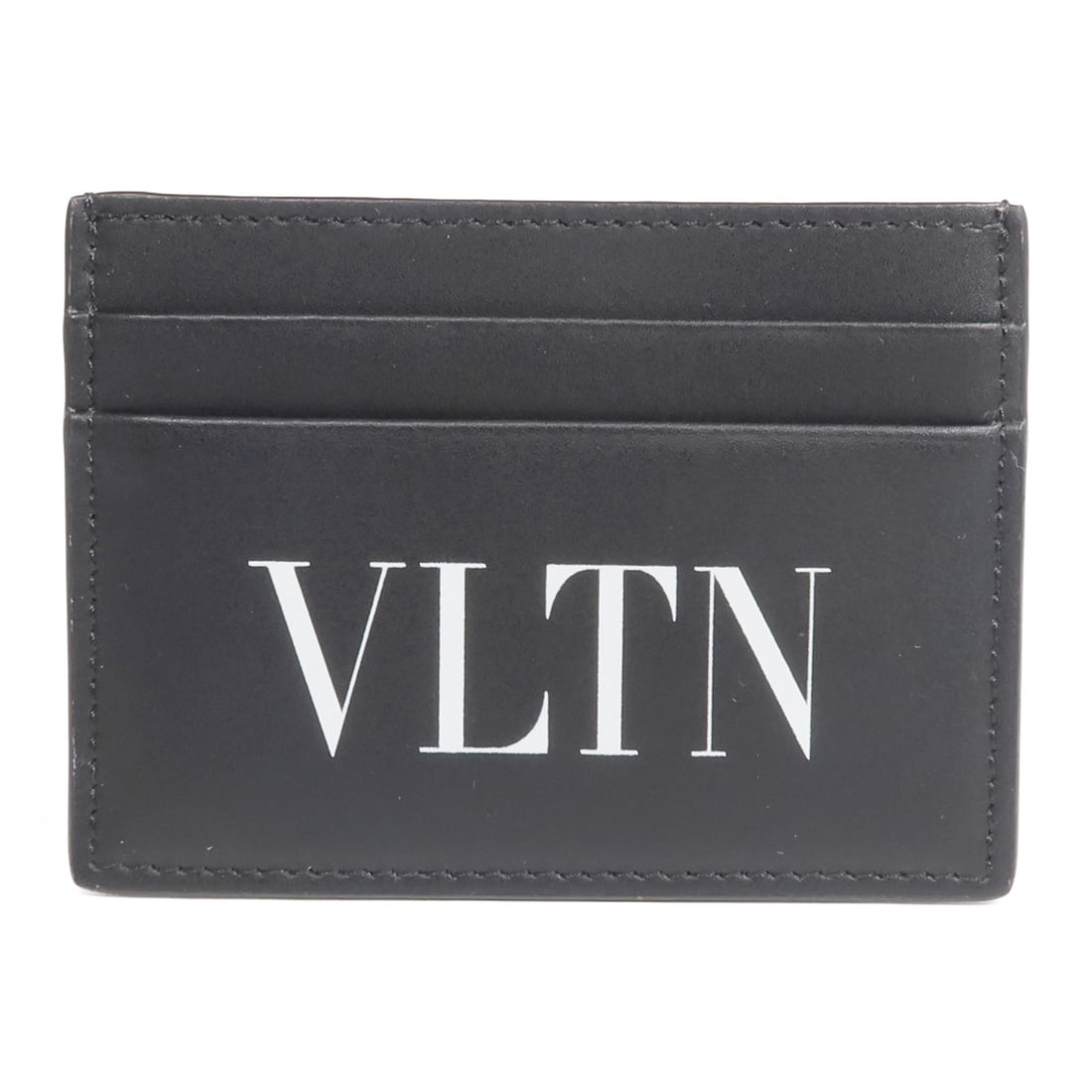 Black Calfskin Leather Card Case by Valentino Unisex: Black Calfskin Leather Card Case by Valentino Unisex This Valentino card case is crafted from black calfskin leather and features a sleek, unisex design. Made in Italy, it offers a sophisticated and p
