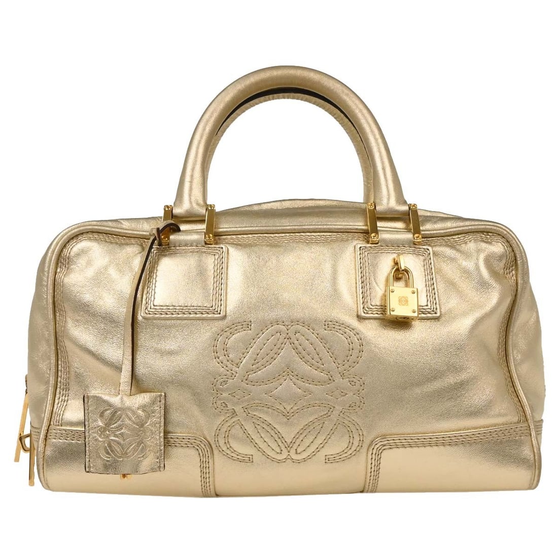 Loewe Amazona 28 Metallic Gold Leather Handbag: Loewe Amazona 28 Metallic Gold Leather Handbag Elevate your accessory collection with the Loewe Metallic Gold Leather Amazona 28 Handbag. Crafted in Spain, this medium-sized top handle bag features a