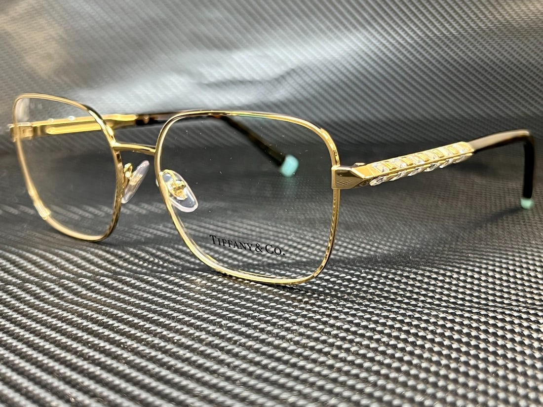 Tiffany TF1140B 6021 Pale Gold Rectangle Women's Eyeglasses with Authenticity: Tiffany TF1140B 6021 Pale Gold Rectangle Women's Eyeglasses with Authenticity Elevate your eyewear collection with these Tiffany TF1140B 6021 eyeglasses, featuring a chic pale gold rectangular frame.