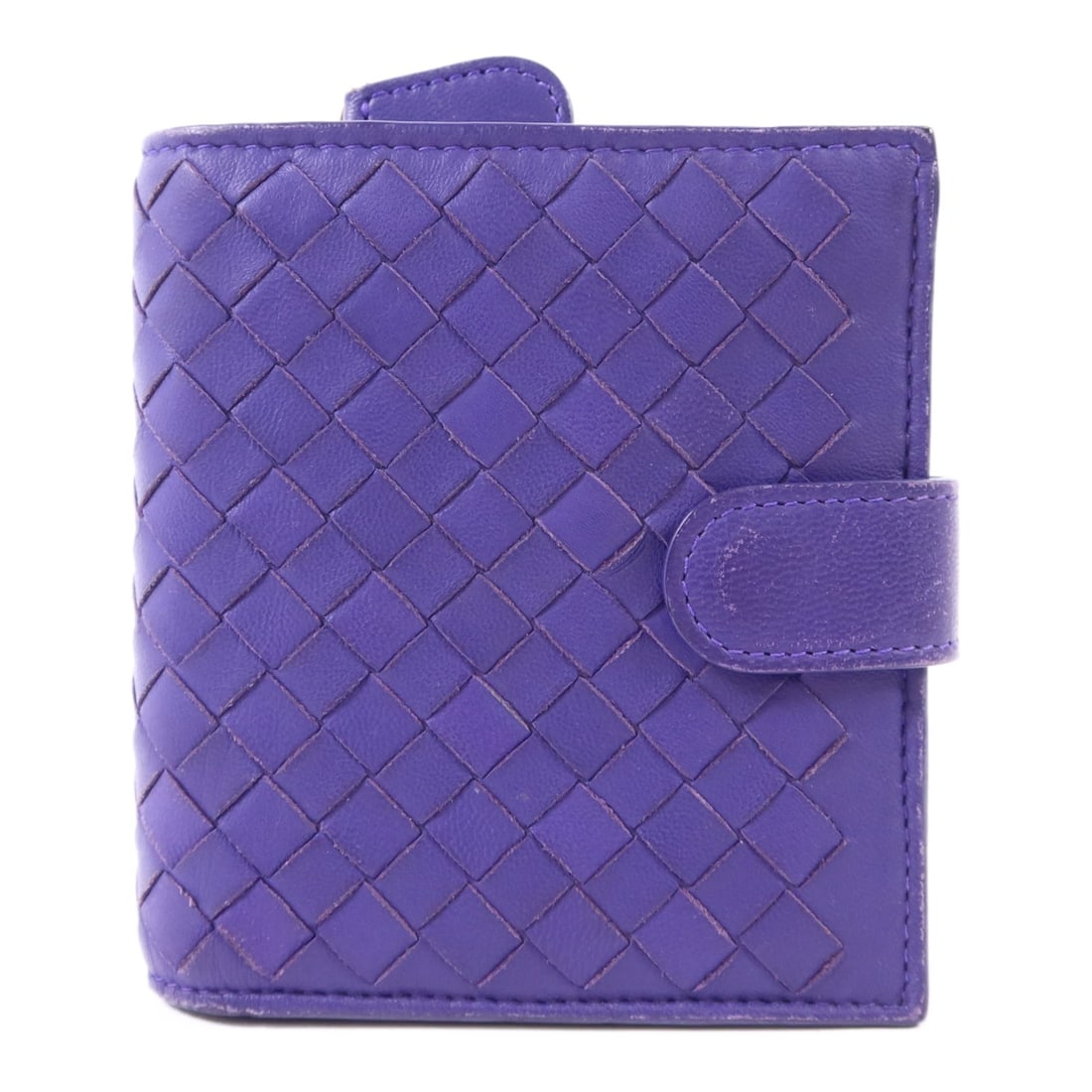 Purple Lambskin Bifold Wallet by Bottega Veneta with Gold Tone Snap: Purple Lambskin Bifold Wallet by Bottega Veneta with Gold Tone Snap This Bottega Veneta bifold snap wallet is crafted from soft lambskin leather in a striking purple color. Designed in a regular size,