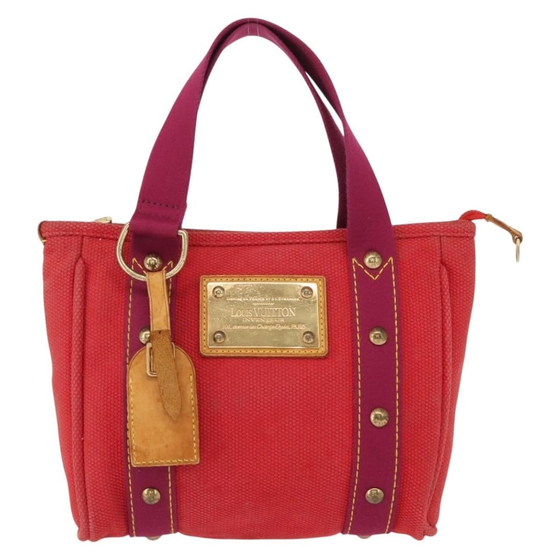 Louis Vuitton Red Canvas Antigua Tote Bag 23cm x 20cm x 7cm: Louis Vuitton Red Canvas Antigua Tote Bag 23cm x 20cm x 7cm This Louis Vuitton Antigua Tote for women is crafted from red canvas with leather accents and metal fittings. The bag shows signs of wear in