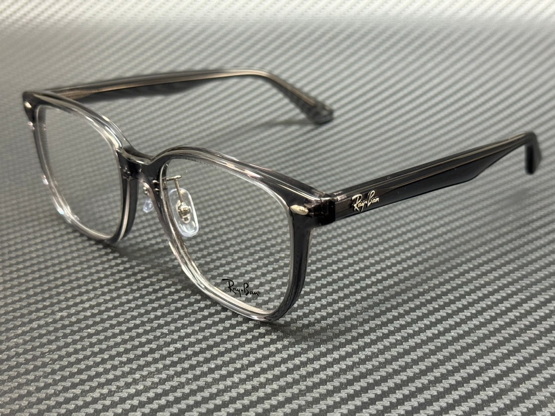 Ray-Ban RX5425D 8268 Transparent Grey 54mm Unisex Eyeglasses: Ray-Ban RX5425D 8268 Transparent Grey 54mm Unisex Eyeglasses Introducing the Ray-Ban RX5425D 8268 eyeglasses, a stylish and contemporary addition to your eyewear collection. Featuring a transparent gr