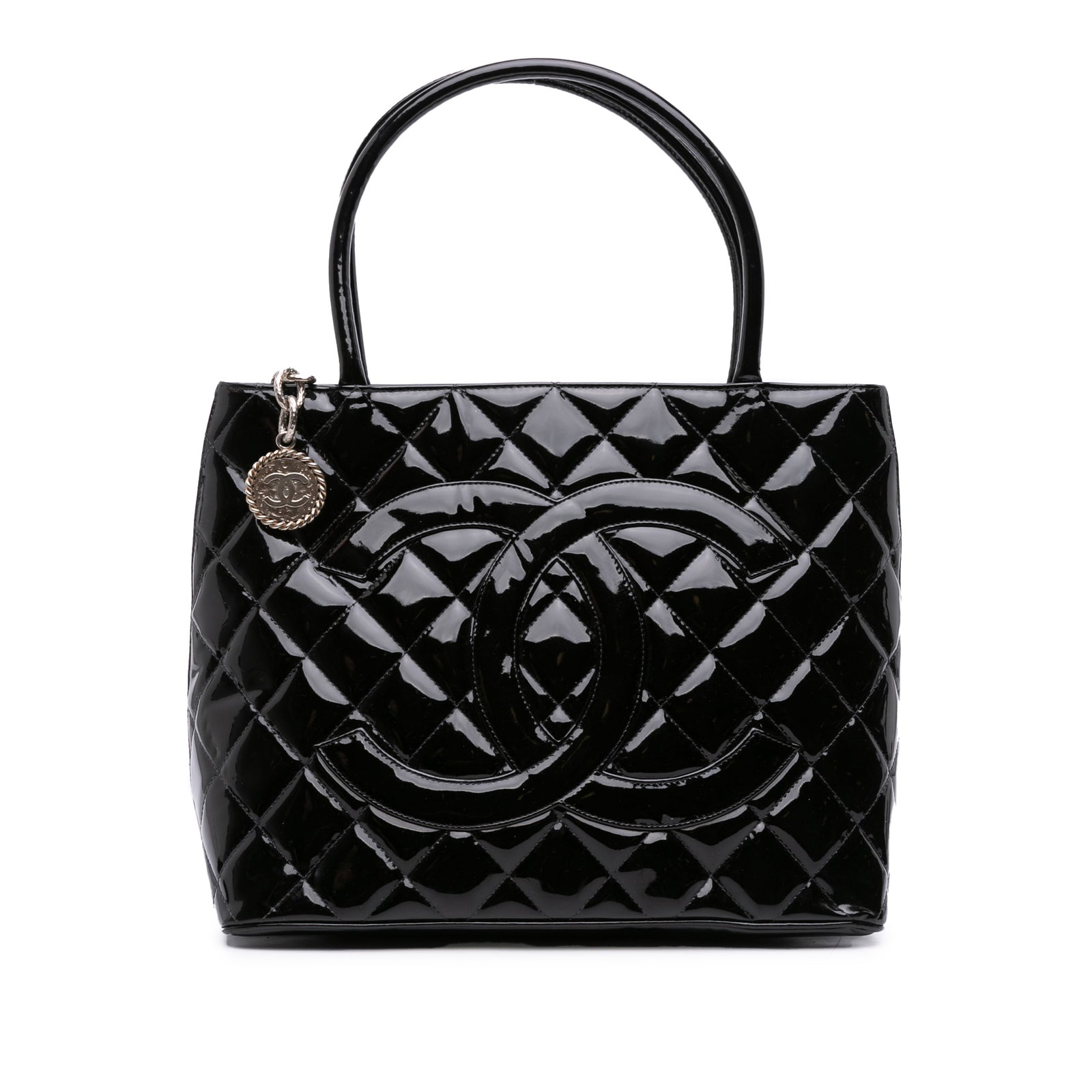 Chanel Black Patent Leather Quilted Medallion Tote Bag with Top Zip: Chanel Black Patent Leather Quilted Medallion Tote Bag with Top Zip This Chanel Medallion Tote features a quilted patent leather exterior in black, complemented by rolled leather handles. The bag is d