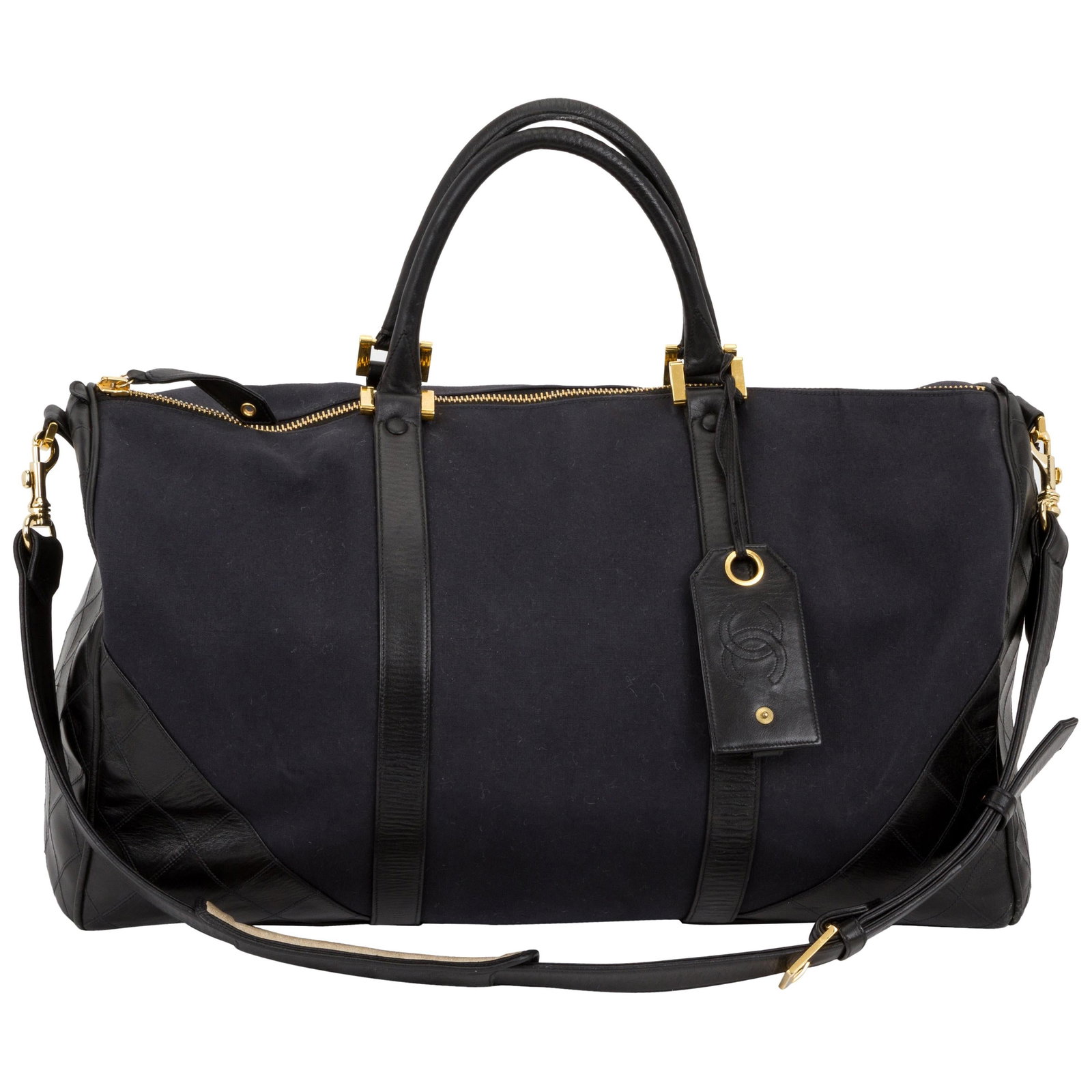 Chanel Vintage 90s Quilted Canvas Leather Duffle Bag with Gold Tone Hardware: Chanel Vintage 90s Quilted Canvas Leather Duffle Bag with Gold Tone Hardware This Chanel vintage duffle bag from the late 80s to early 90s is a stylish and functional accessory crafted from durable ca