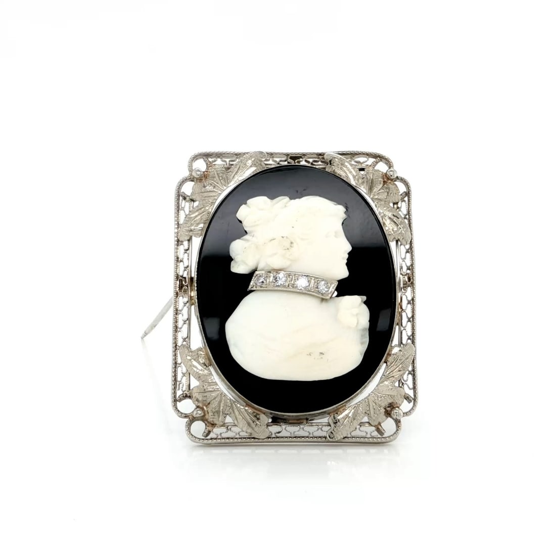 Vintage 14k White Gold Cameo Brooch Pendant With Diamond and Onyx Filigree: Vintage 14k White Gold Cameo Brooch Pendant With Diamond and Onyx Filigree This vintage cameo brooch and pendant is crafted from 14k white gold, featuring a refined floral filigree and milgrain frame.