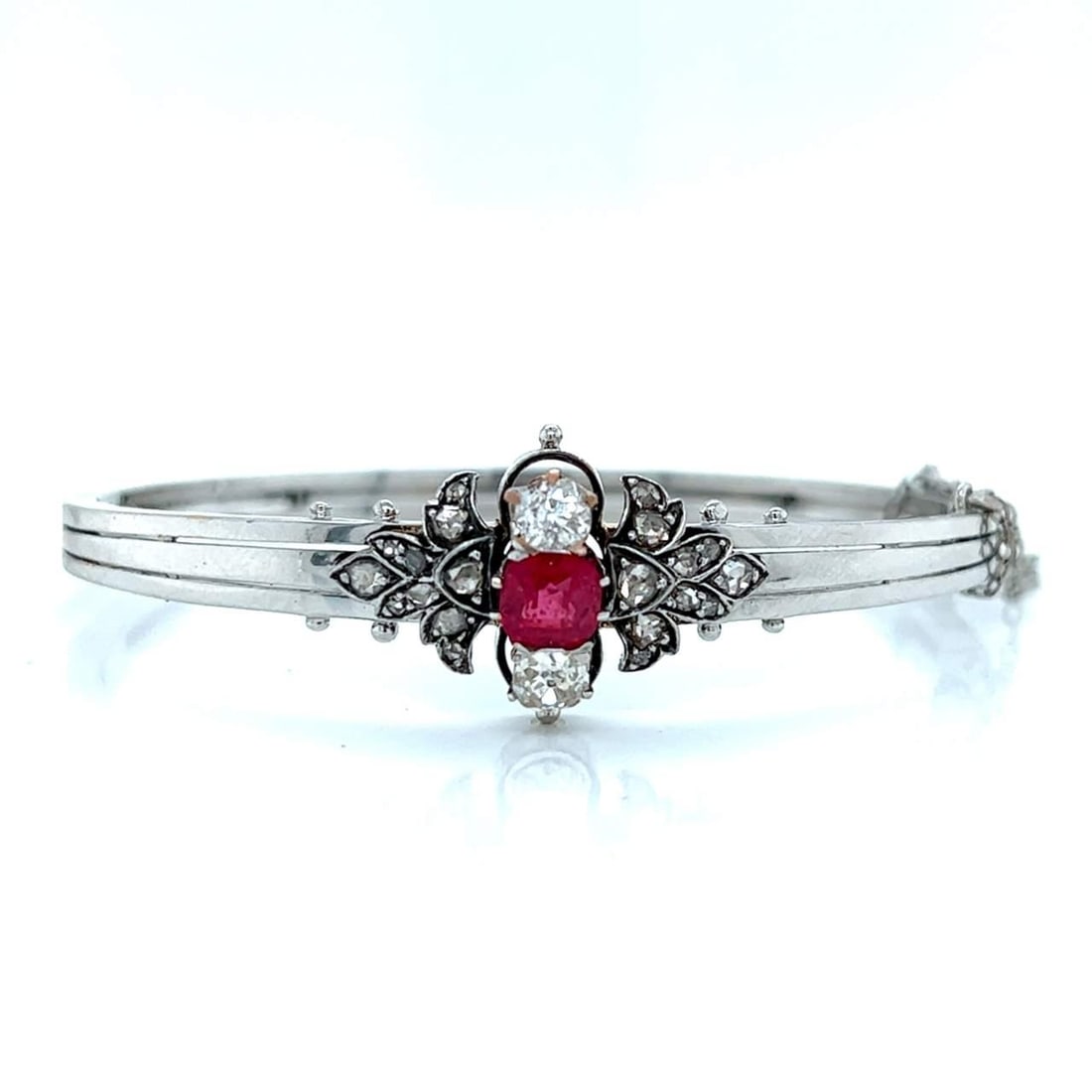 Victorian 14K White Gold Garnet Diamond Bangle with 22 Diamonds: Victorian 14K White Gold Garnet Diamond Bangle with 22 Diamonds This exquisite Victorian bangle is crafted in 14K white gold and features a stunning design highlighted by a central garnet and sparklin