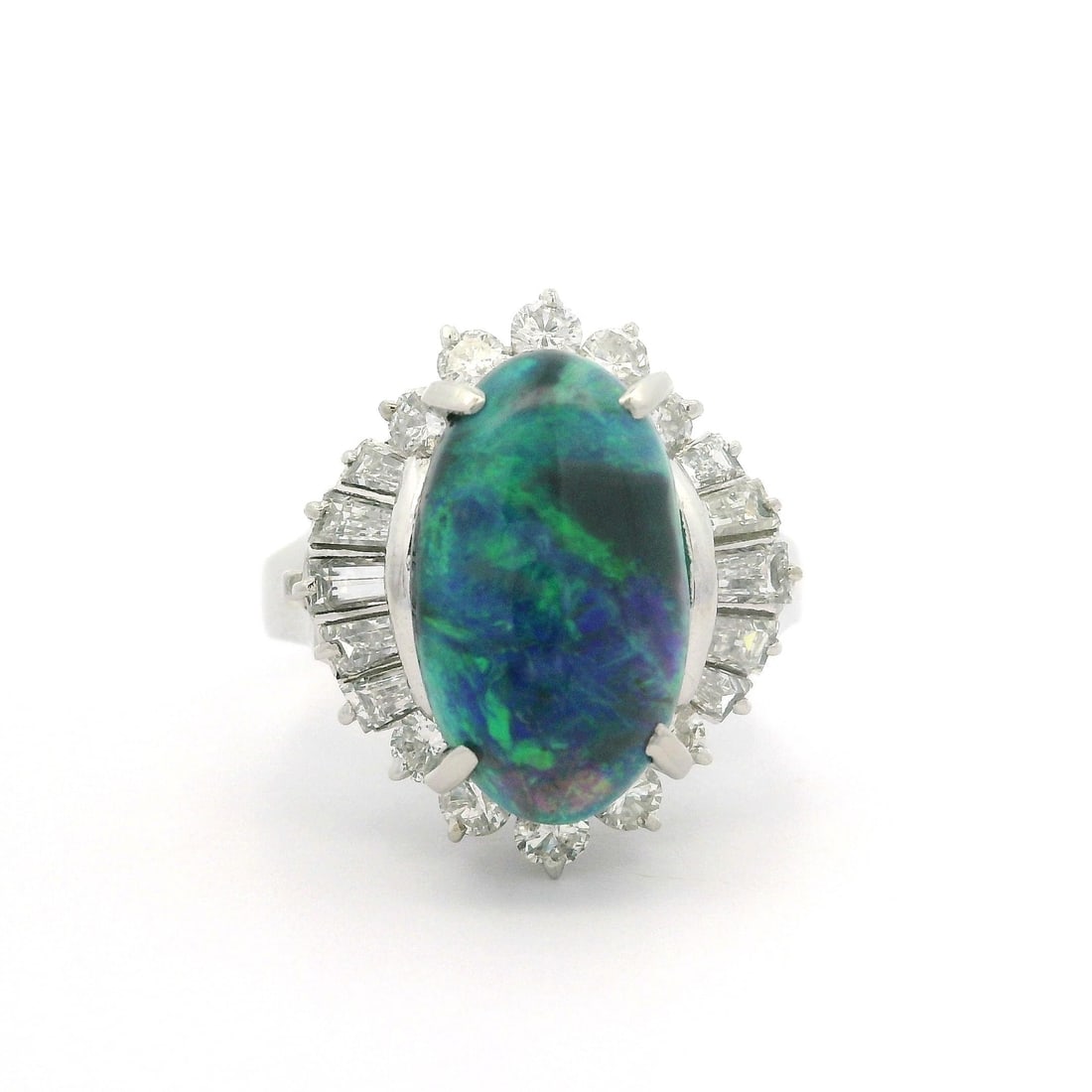 Platinum GIA Certified 4.04ctw Black Opal Diamond Ballerina Ring: Platinum GIA Certified 4.04ctw Black Opal Diamond Ballerina Ring This exquisite ballerina cocktail ring features a stunning elongated oval black opal at its center, showcasing a remarkable play of gre