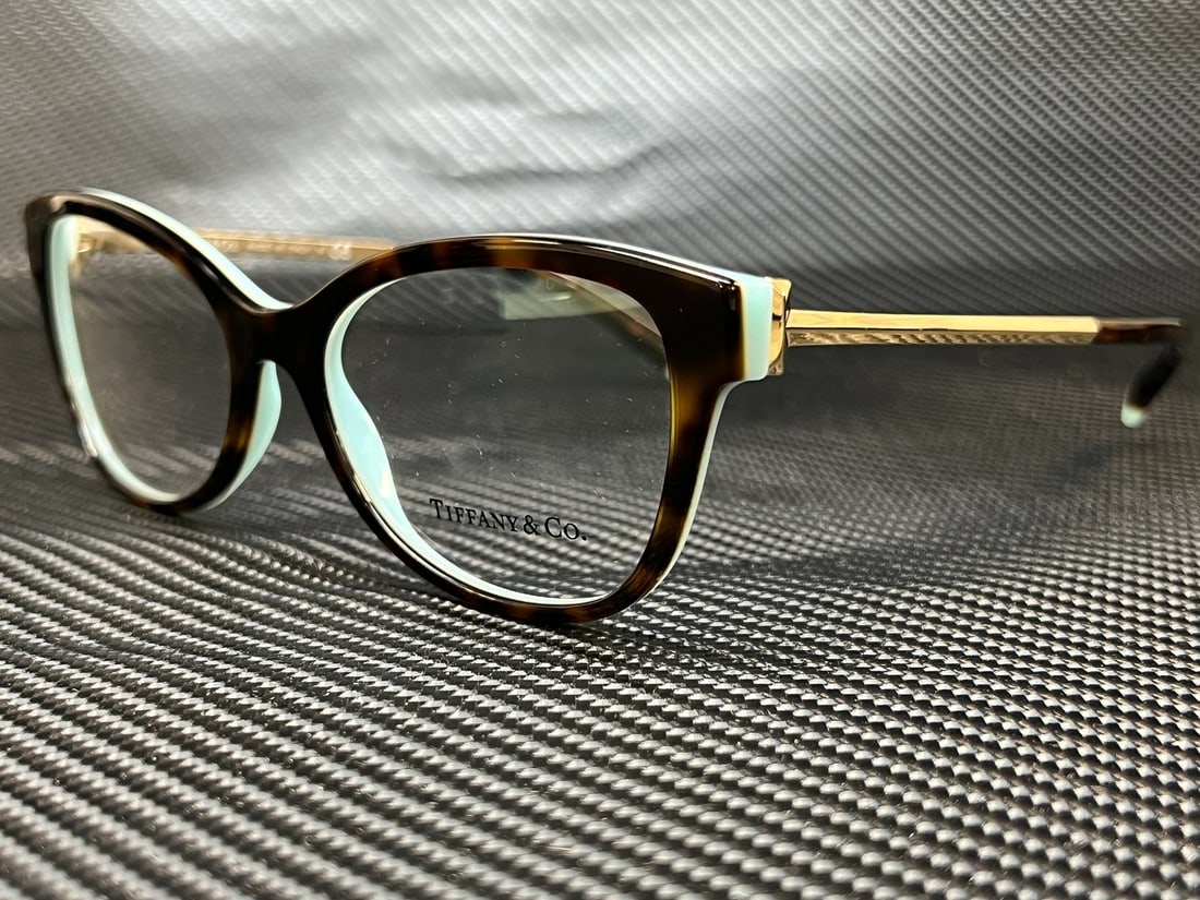 Tiffany & Co. TF2190 8134 Havana Blue Women Eyeglasses with Demo Lens: Tiffany & Co. TF2190 8134 Havana Blue Women Eyeglasses with Demo Lens Discover the elegance of Tiffany & Co. with these TF2190 8134 Havana Blue Women Butterfly Eyeglasses. Designed for sophistication,