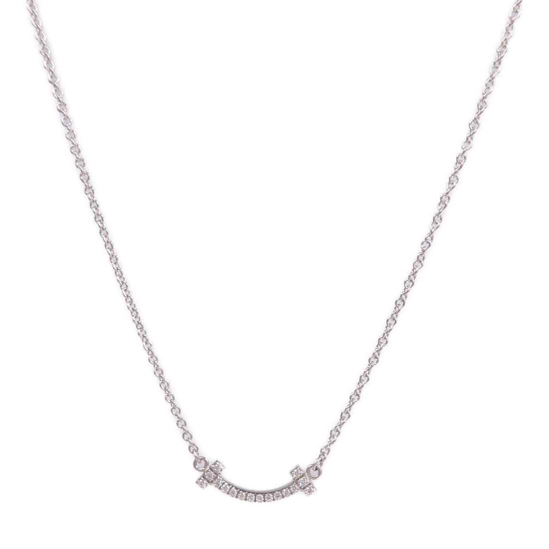 Tiffany T Smile 18K White Gold Diamond Pendant Necklace for Women: Tiffany T Smile 18K White Gold Diamond Pendant Necklace for Women This Tiffany & Co. T Smile necklace features a delicate design crafted from 18K white gold and adorned with sparkling diamonds. Design