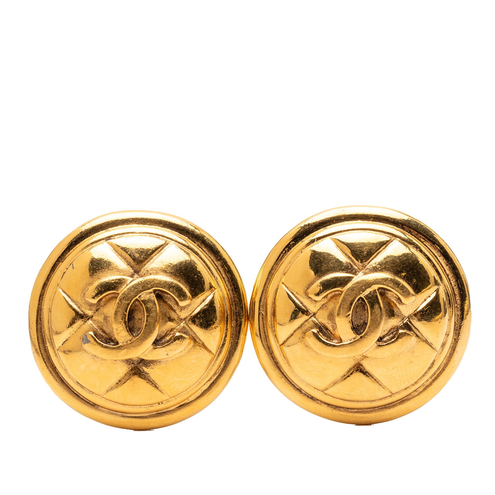 Chanel CC Round Quilted Gold Plated Clip On Costume Earrings: Chanel CC Round Quilted Gold Plated Clip On Costume Earrings These Chanel earrings feature a gold plated metal construction with a classic round, quilted CC design and a clip-on closure. Made in Franc