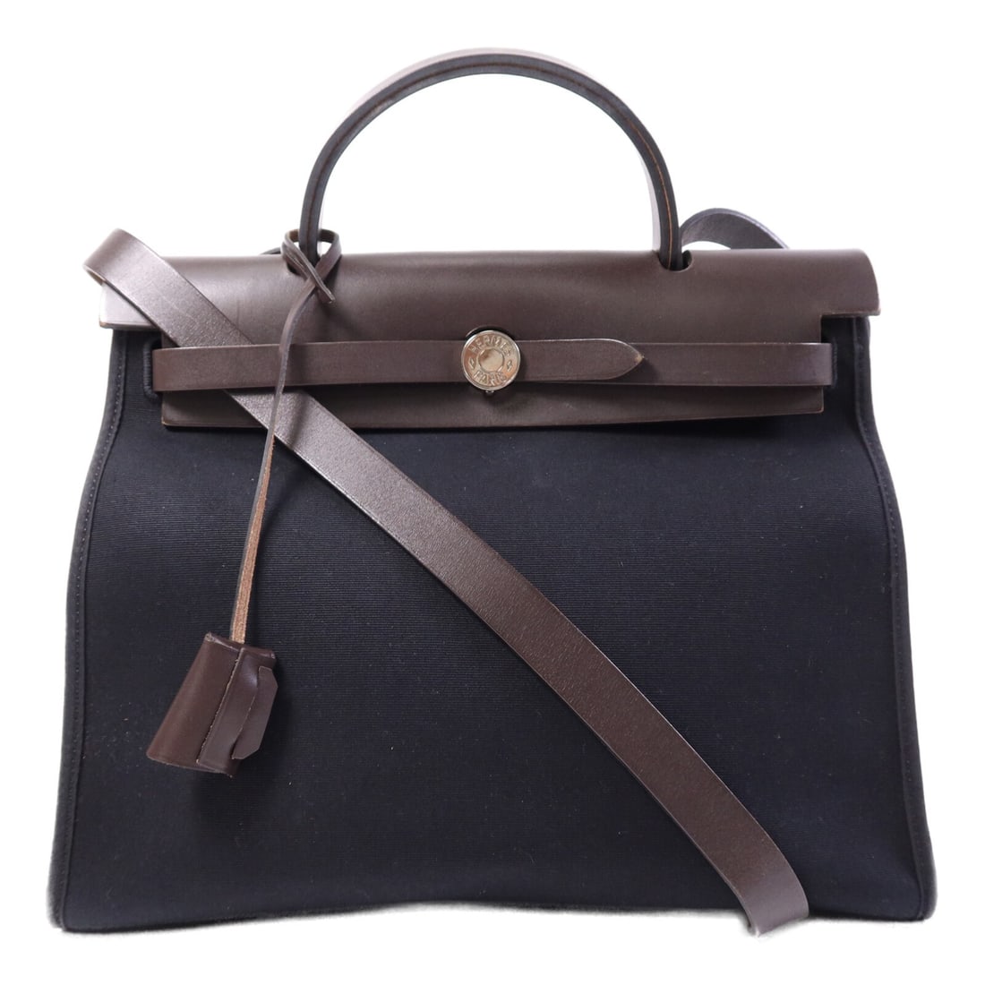 Herbag PM Black Canvas Shoulder and Tote Bag by Hermes with Palladium Hardware: Herbag PM Black Canvas Shoulder and Tote Bag by Hermes with Palladium Hardware This Hermes Herbag PM is a versatile 2-way shoulder bag crafted from black canvas. Designed for women, the bag features a