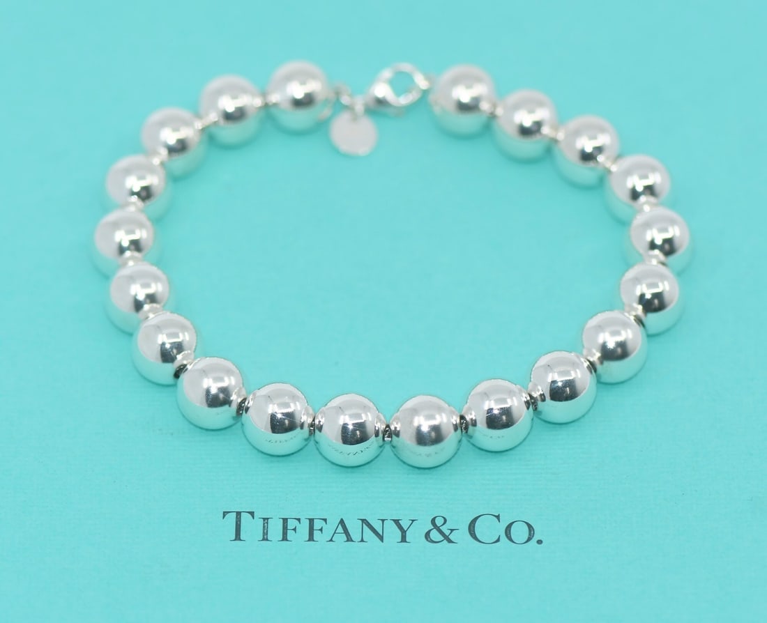Sterling Silver Beaded Bracelet by Tiffany & Co 8 Inch with Pouch: Sterling Silver Beaded Bracelet by Tiffany & Co 8 Inch with Pouch This pre-owned Tiffany & Co. beaded bracelet features 925 sterling silver beads and a bead-style charm. The bracelet does not include