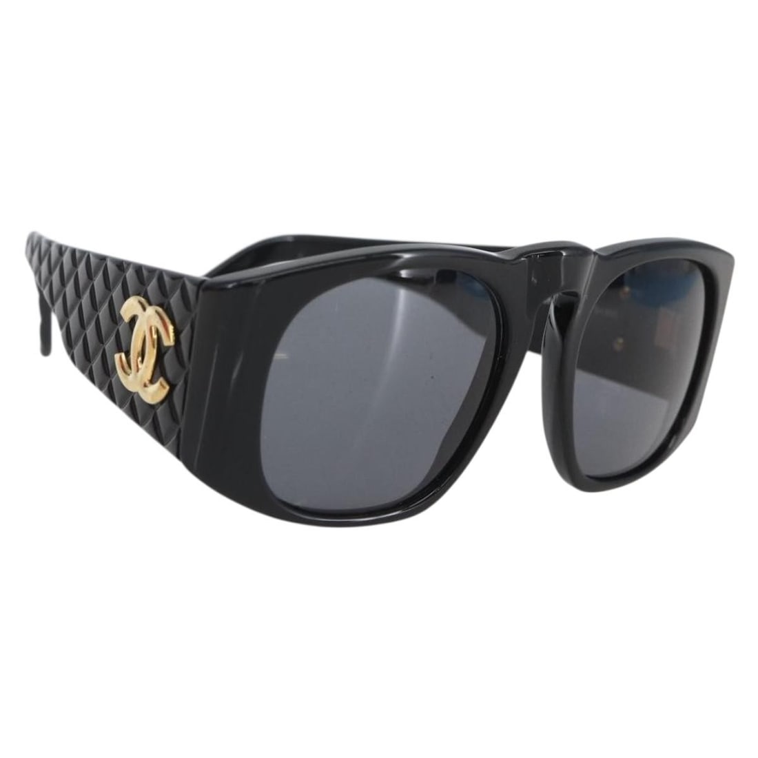Black Plastic CHANEL Matelasse Sunglasses with CC Logo Italy: Black Plastic CHANEL Matelasse Sunglasses with CC Logo Italy These CHANEL Matelasse sunglasses feature a classic black plastic frame and the iconic CC logo. Made in Italy, they offer a stylish and rec