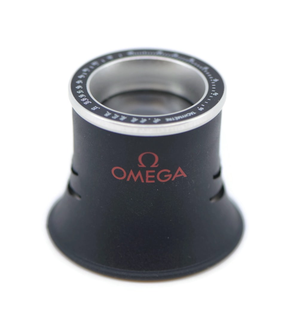 Watchmakers Loupe Magnifier for Omega Speedmaster Swiss Tool: Watchmakers Loupe Magnifier for Omega Speedmaster Swiss Tool This Omega Speedmaster watch loupe is a precision tool designed for detailed viewing and inspection. Manufactured in Switzerland by OMEGA,