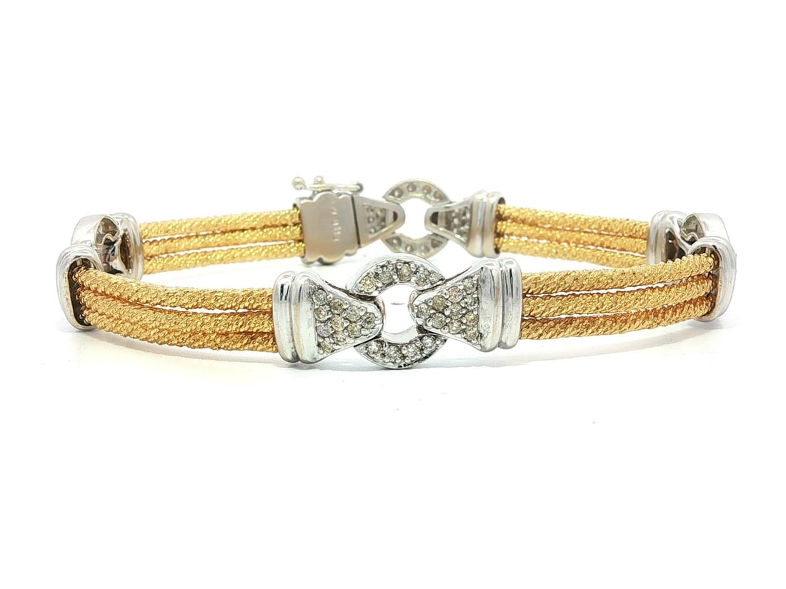 Diamond Station Bracelet 18k Yellow and White Gold 1.10ctw Textured Tube Links: Diamond Station Bracelet 18k Yellow and White Gold 1.10ctw Textured Tube Links This women's bracelet features a station link design crafted in solid 18k two tone gold, combining yellow gold with white