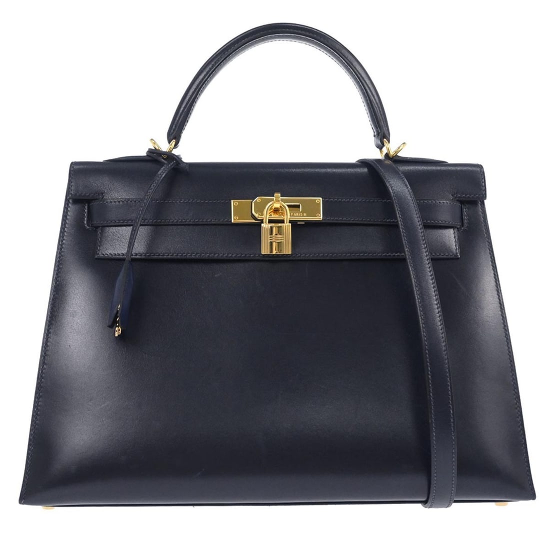 Navy Leather Kelly 32 Sellier Two Way Satchel by Hermes: Navy Leather Kelly 32 Sellier Two Way Satchel by Hermes This Hermes Kelly 32 Sellier handbag features a refined navy box calf leather exterior and a medium-sized structure. Designed with a top handle,
