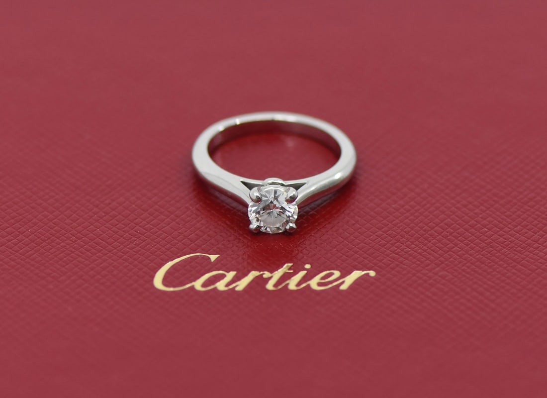 Cartier 0.70ct E VVS2 Round Diamond Platinum Engagement Ring Size 49: Cartier 0.70ct E VVS2 Round Diamond Platinum Engagement Ring Size 49 This exquisite Cartier engagement ring features a stunning 0.70 ct round diamond, graded E for color and VVS2 for clarity, ensuring