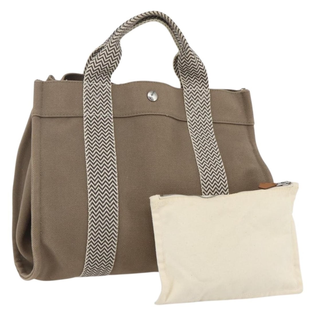 Beige Cotton Cannes Tote Bag by Hermes France: Beige Cotton Cannes Tote Bag by Hermes France This Hermes Cannes Tote is crafted from beige cotton canvas and designed for women. It features a spacious interior and practical handles, with minor sign