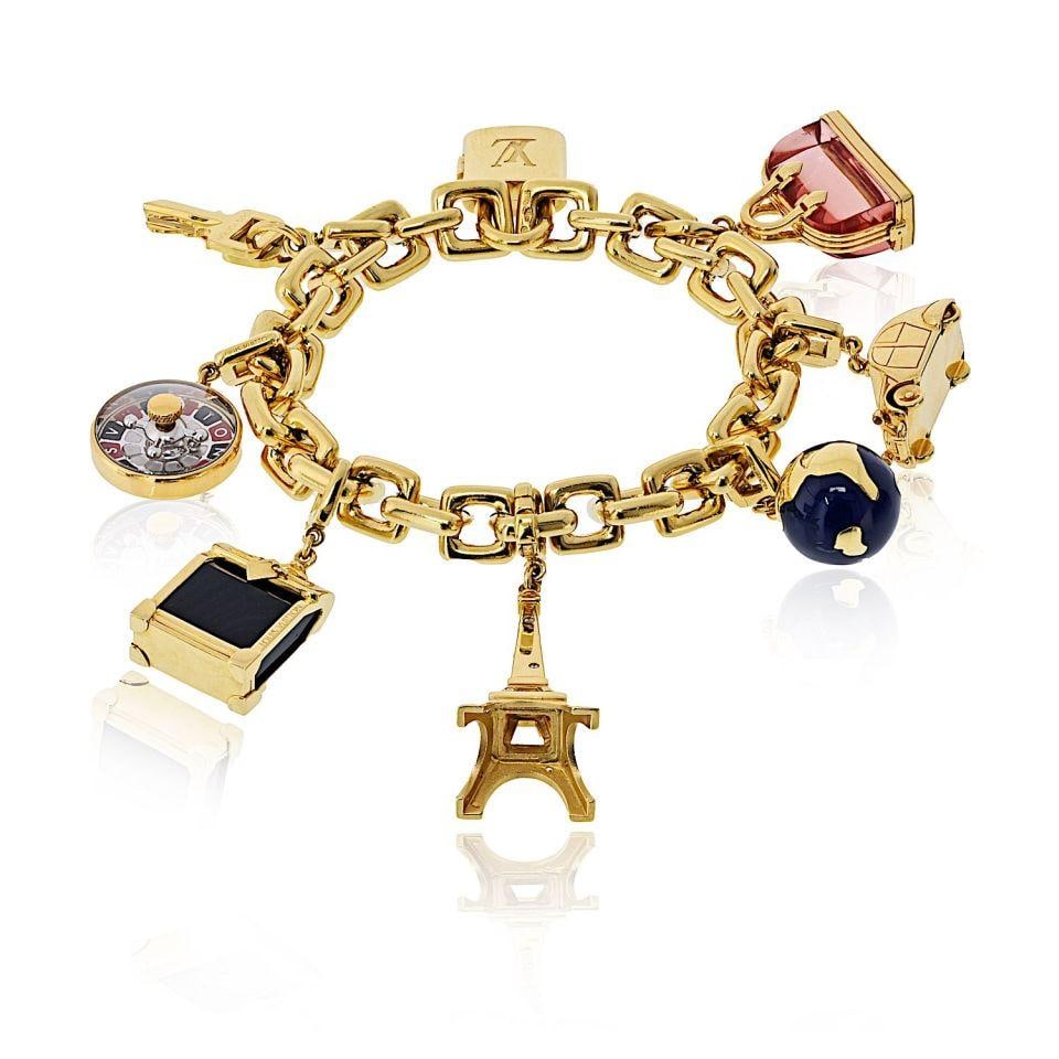Louis Vuitton 18K Gold Bracelet with Eight Charms Including Padlock and Eiffel Tower: Louis Vuitton 18K Gold Bracelet with Eight Charms Including Padlock and Eiffel Tower This pre-owned bracelet is crafted from 18K yellow gold and features eight distinctive charms, including a padlock,