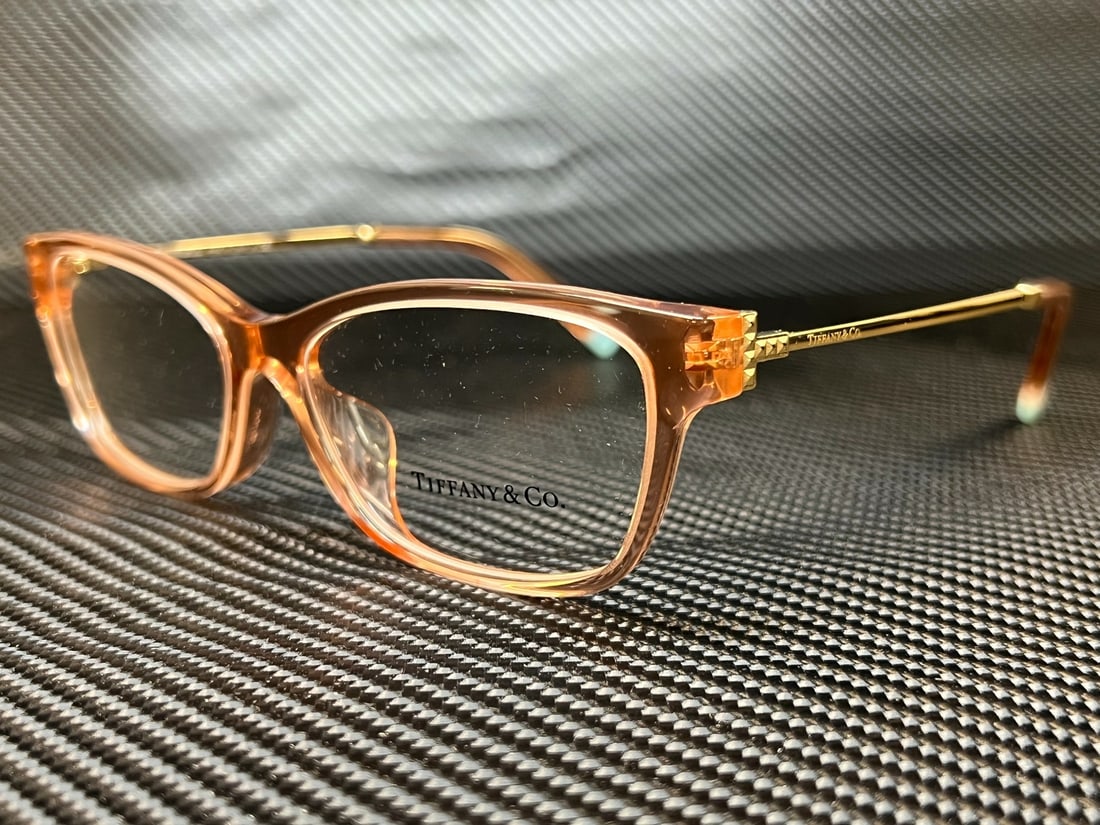 Tiffany & Co. TF2204F 8332 Peach Transparent Women's Eyeglasses: Tiffany & Co. TF2204F 8332 Peach Transparent Women's Eyeglasses Elevate your eyewear collection with these Tiffany & Co. TF2204F 8332 eyeglasses, designed specifically for women. Featuring a stylish p