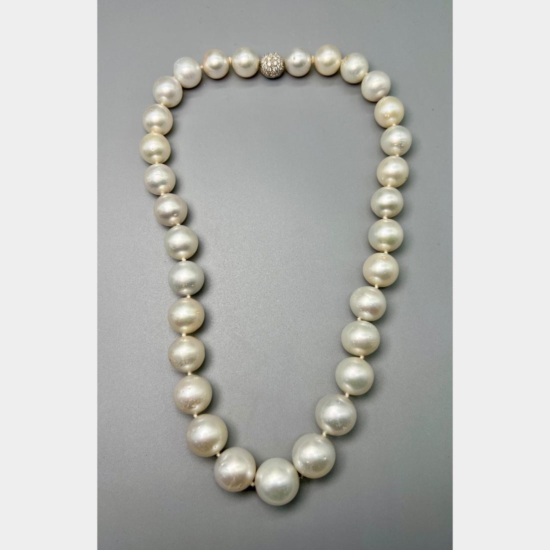31 South Sea Pearl Strand with 18K White Gold Diamond Clasp 18 Inch: 31 South Sea Pearl Strand with 18K White Gold Diamond Clasp 18 Inch This necklace features graduated South Sea pearls, each measuring between 15.2 mm and 12.0 mm, strung on 18K white gold. The clasp i