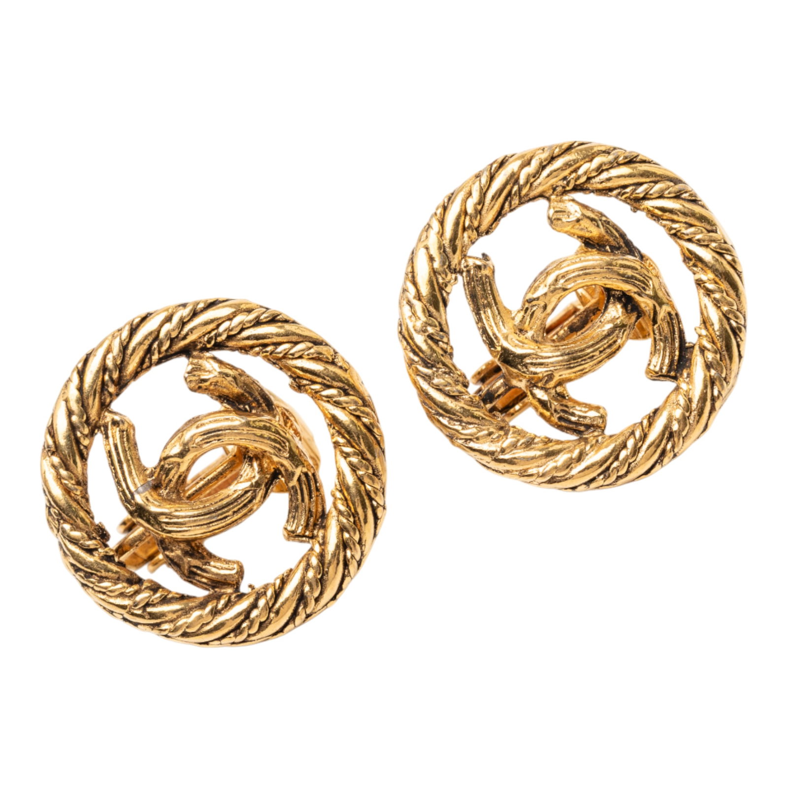 Chanel CC Logo Gold Plated Metal Round Clip Earrings: Chanel CC Logo Gold Plated Metal Round Clip Earrings These Chanel earrings feature round gold-plated metal bodies with clip-on closures. Designed as part of the brand's costume jewelry line, they show