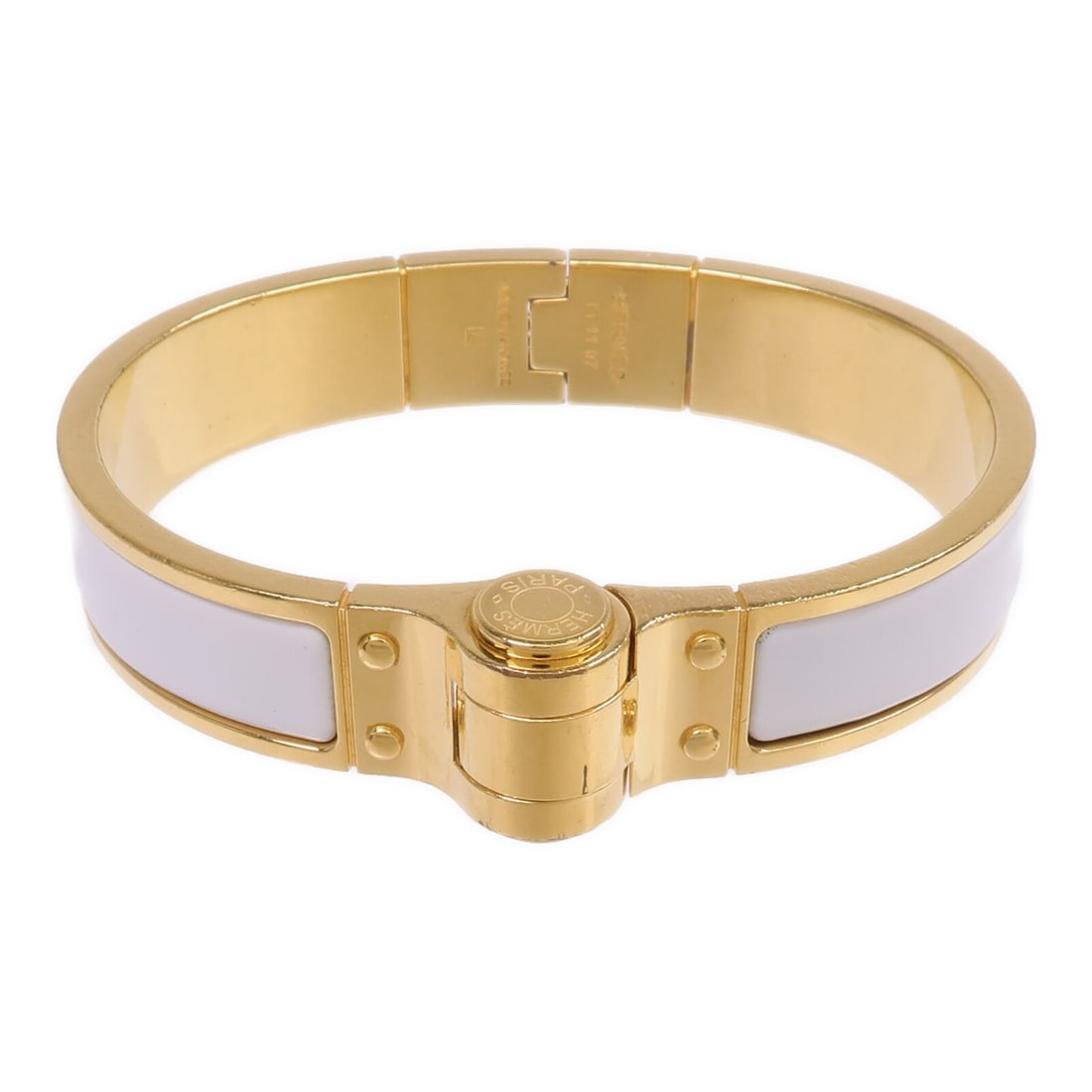 White Enamel Charniere Bracelet by Hermes Gold Tone Metal: White Enamel Charniere Bracelet by Hermes Gold Tone Metal This Hermes Charniere bracelet features a white enamel design with metal accents. Crafted in France, it has a sleek and stylish appearance sui