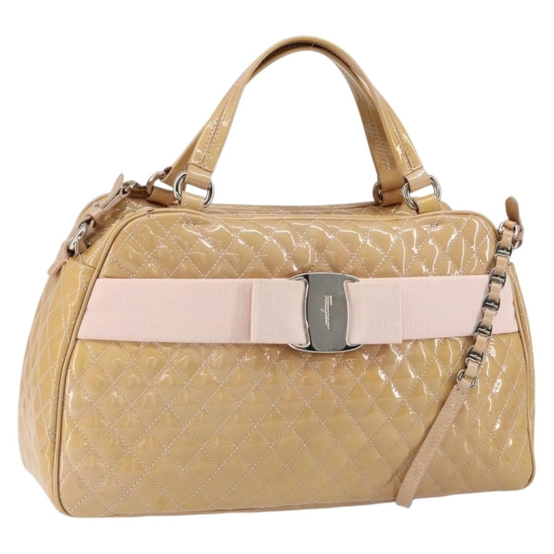 Beige Patent Leather Vala Handbag by Salvatore Ferragamo: Beige Patent Leather Vala Handbag by Salvatore Ferragamo This pre-owned Salvatore Ferragamo Vala handbag, crafted from beige patent leather, is designed for women. It shows signs of use, including sur