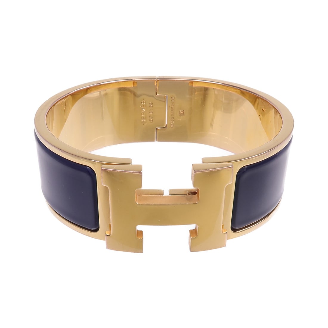 Enamel Gold Tone Clic Clac H Bracelet by Hermes Navy: Enamel Gold Tone Clic Clac H Bracelet by Hermes Navy This Hermes Clic Clac H bracelet features gold-tone enamel with a navy accent. Designed for women, it offers a sophisticated and versatile accessor