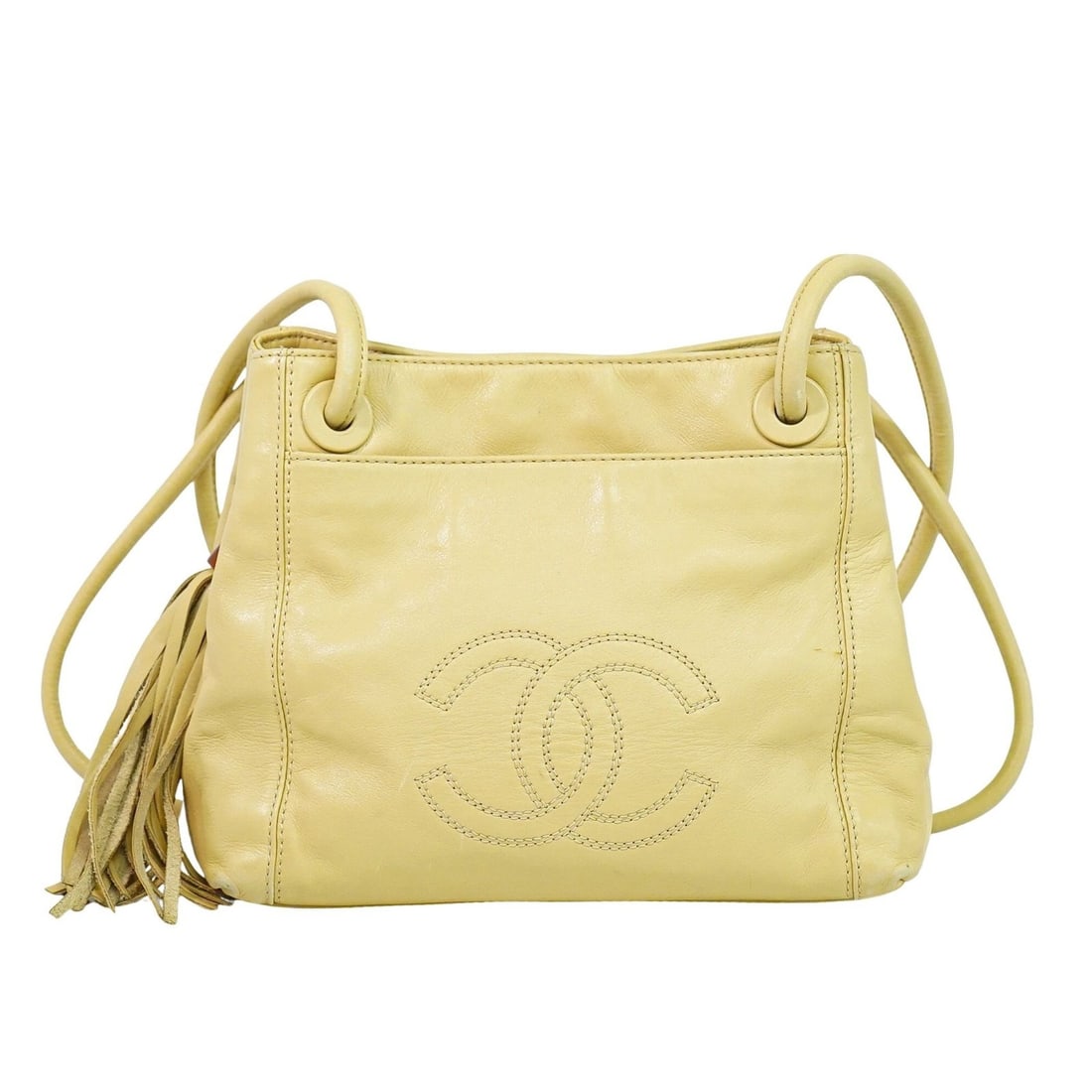 Beige Lambskin Shoulder Bag by Chanel with CC Tassel Vintage Design: Beige Lambskin Shoulder Bag by Chanel with CC Tassel Vintage Design This Chanel Vintage CC Tassel Shoulder Bag is crafted from beige lambskin leather, designed for women. It features a classic shoulde