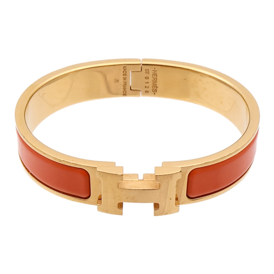 Orange Enamel and Metal Clic H Bracelet by Hermes: Orange Enamel and Metal Clic H Bracelet by Hermes This is a Hermes Clic H bracelet crafted from orange enamel with metal accents. The bracelet features a regular size and does not include any gemstone