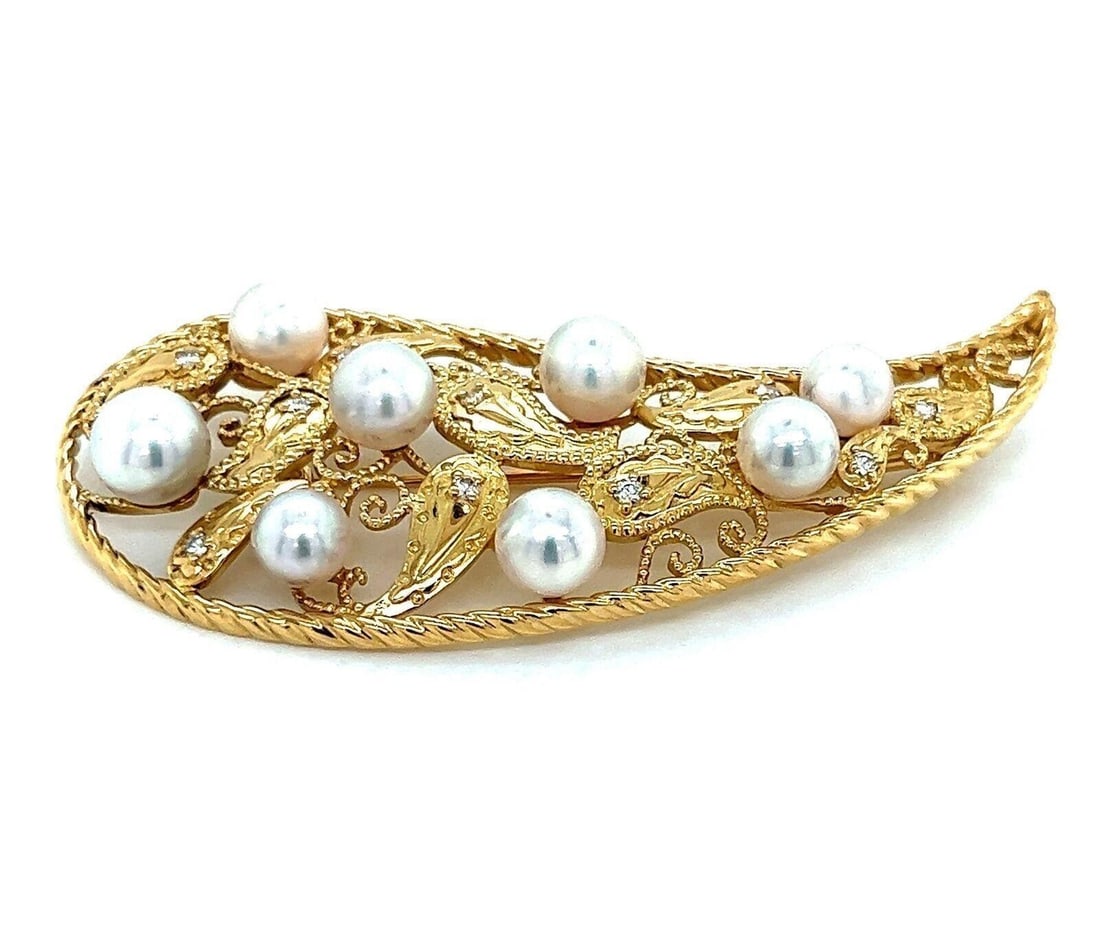 Estate 18k Yellow Gold Brooch with Akoya Pearls and Diamond Accent by Mikimoto: Estate 18k Yellow Gold Brooch with Akoya Pearls and Diamond Accent by Mikimoto This authentic estate brooch by Mikimoto is crafted from solid 18k yellow gold and features a large open teardrop frame a