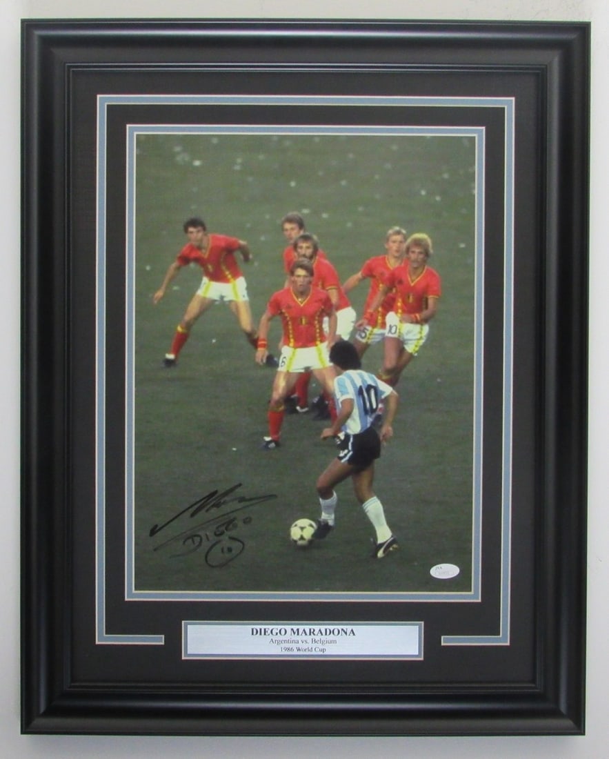 Framed 11x14 Photo Signed by Diego Maradona Argentina vs Belgium JSA Authenticated: Framed 11x14 Photo Signed by Diego Maradona Argentina vs Belgium JSA Authenticated This framed 11x14 photo captures Diego Maradona during the Argentina vs Belgium match and features his authentic sign