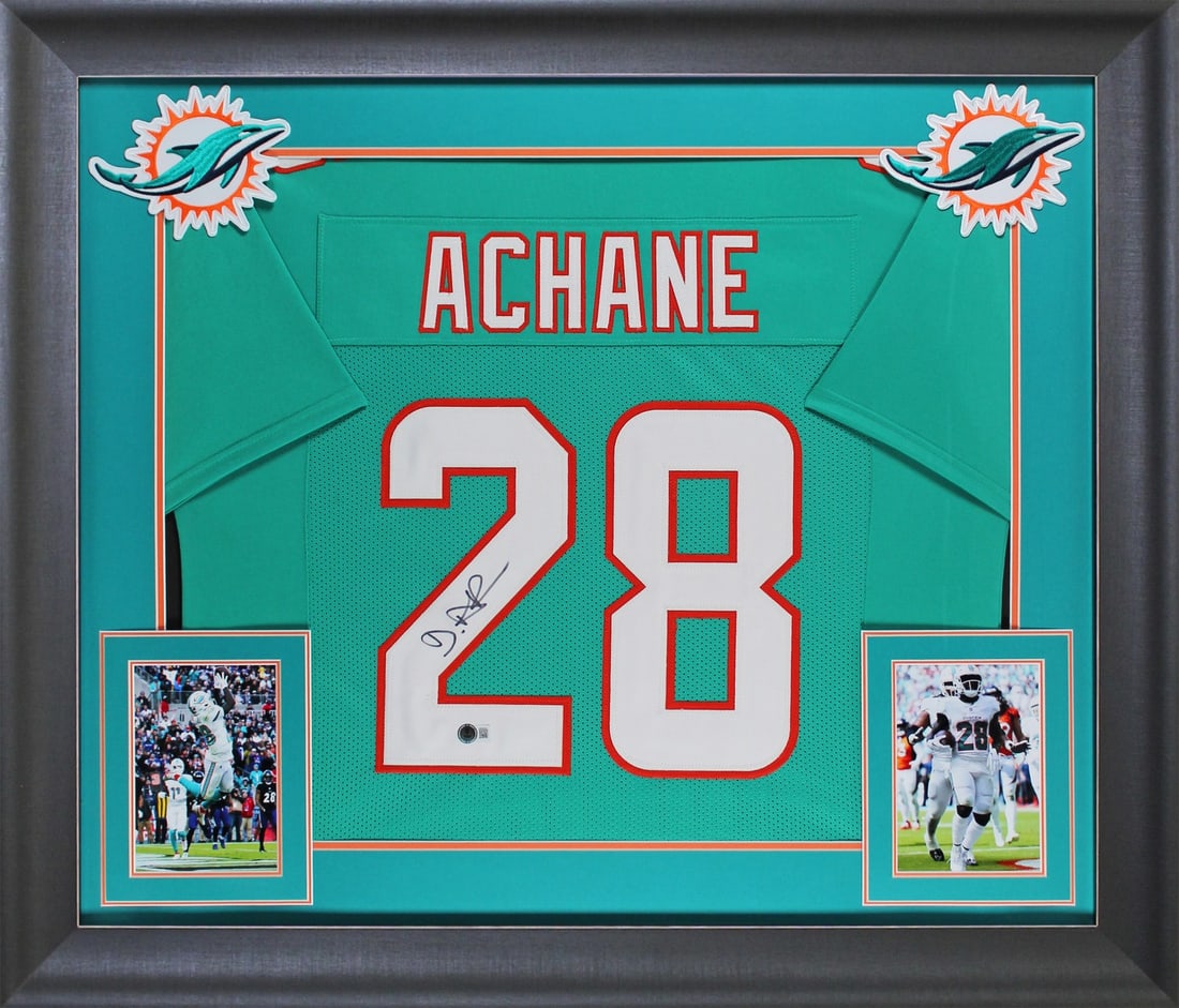 Framed Teal Jersey Signed by De'Von Achane with Beckett Witness Authentication: Framed Teal Jersey Signed by De'Von Achane with Beckett Witness Authentication This teal Pro Style framed jersey has been personally hand-signed by De'Von Achane of the Miami Dolphins. The jersey is c