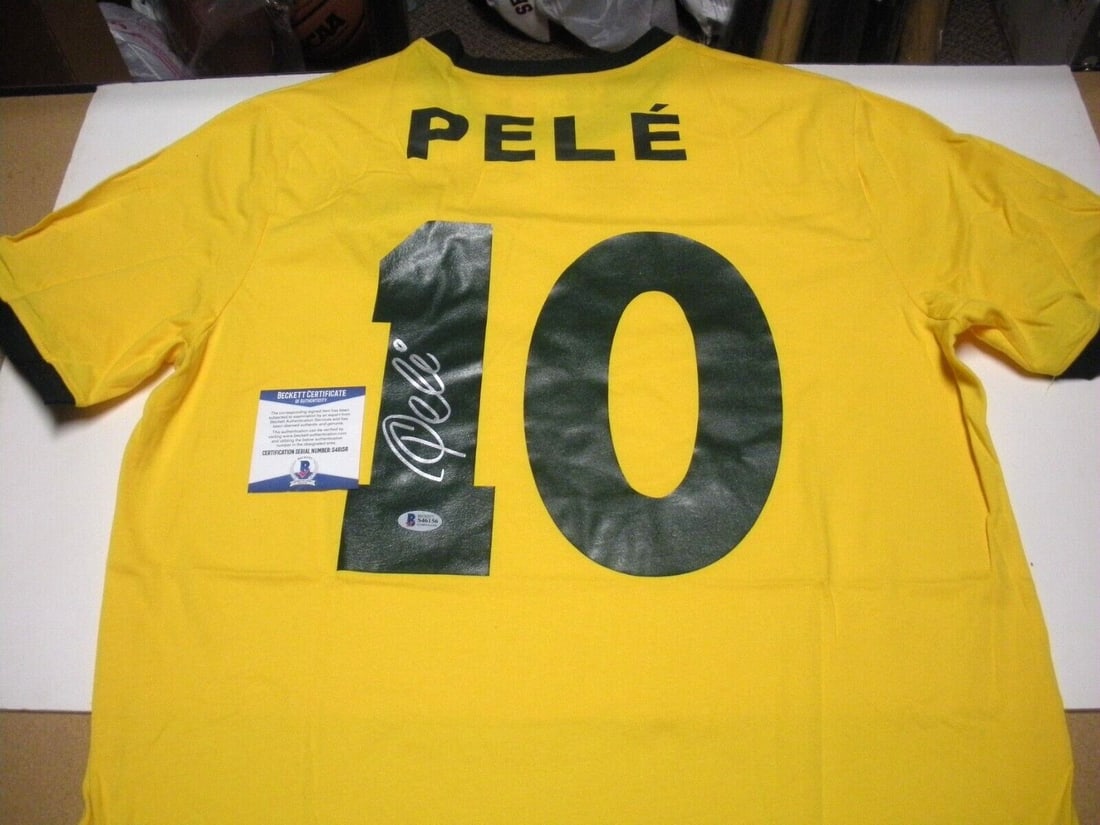 Signed Soccer Jersey Honoring Pele's Brazil World Cup Triumphs with Beckett COA: Signed Soccer Jersey Honoring Pele's Brazil World Cup Triumphs with Beckett COA This pre-owned Brazil soccer jersey has been personally signed by Pele, the legendary star known for his bicycle kick an