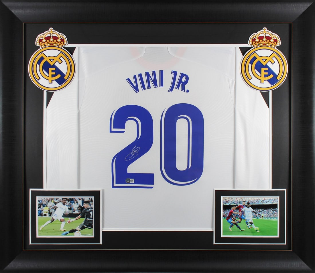 Vincius Vini Jr. Signed Real Madrid Framed Jersey with Beckett Auth: Vincius Vini Jr. Signed Real Madrid Framed Jersey with Beckett Auth Celebrate your passion for soccer with this authentic autographed white Adidas jersey, personally signed by Vincius Vini Jr. of the