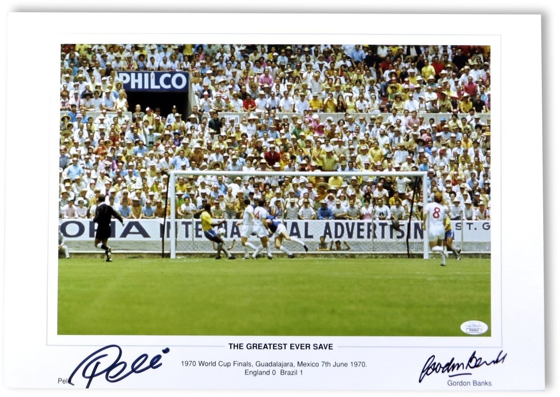 Autographed Soccer Photo Pele and Gordon Banks JSA Authenticated: Autographed Soccer Photo Pele and Gordon Banks JSA Authenticated This autographed photo features both Pele and Gordon Banks, commemorating one of the most iconic moments in soccer history. The photo m