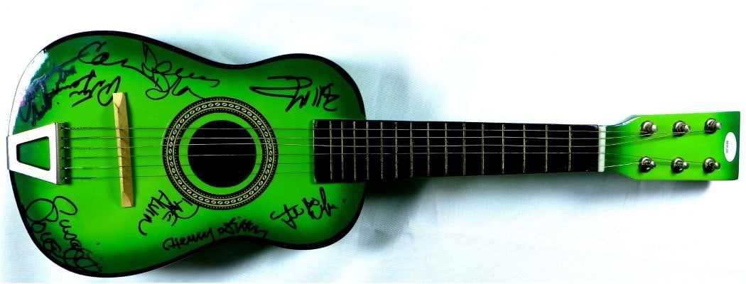 Mini Guitar Signed by Nine Musicians Beckett Authenticated Autographs: Mini Guitar Signed by Nine Musicians Beckett Authenticated Autographs This mini guitar and guitar pick set has been hand-signed by music legends John Sebastian, Henry Diltz, Dave Alvin, Peter Lewis, C