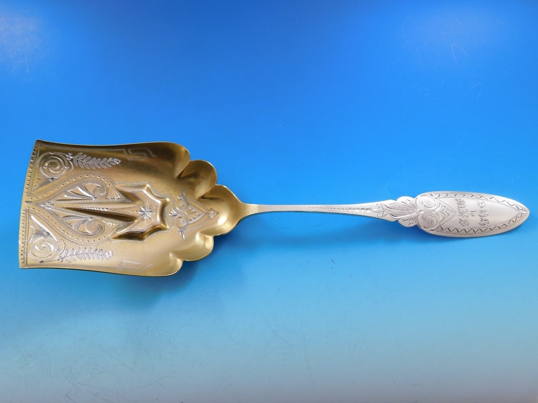 Faber and Son Sterling Silver Cracker Scoop Gold-Washed Bright-Cut 1850-1875: Faber and Son Sterling Silver Cracker Scoop Gold-Washed Bright-Cut 1850-1875 This exquisite cracker scoop is crafted from sterling silver by Faber and Son, showcasing a beautiful bright-cut design. It