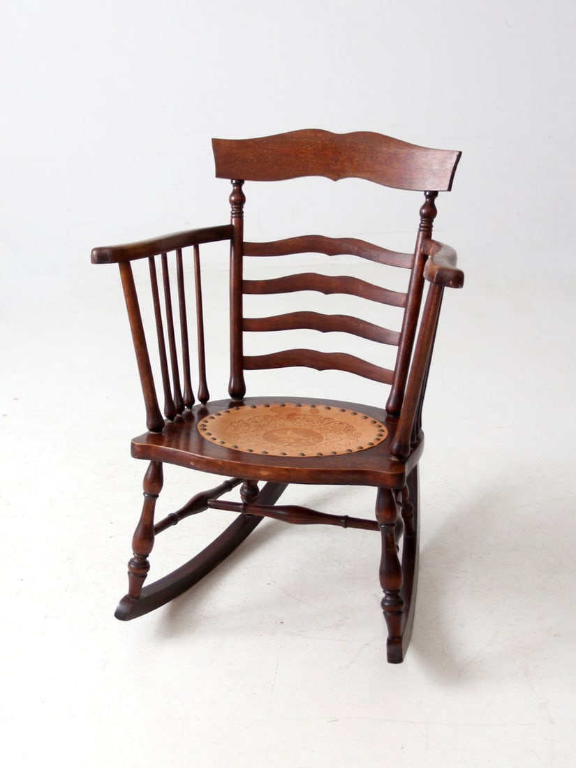 Late 19th Century Antique Ladder Back Rocking Chair with Tooled Leather Seat: Late 19th Century Antique Ladder Back Rocking Chair with Tooled Leather Seat This exquisite late 19th century antique ladder back rocking chair showcases unique mustache-shaped rungs and a beautifully