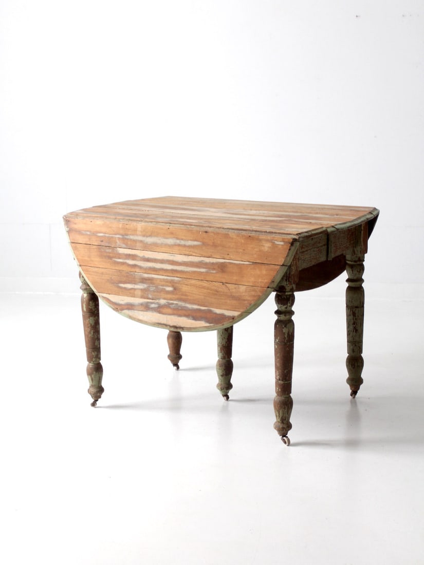 Rustic Antique Drop Leaf Table with Aged Green Finish: Rustic Antique Drop Leaf Table with Aged Green Finish This antique drop leaf table showcases a charming farmhouse design with turned legs and iron hardware that allows the sides to be raised and lower