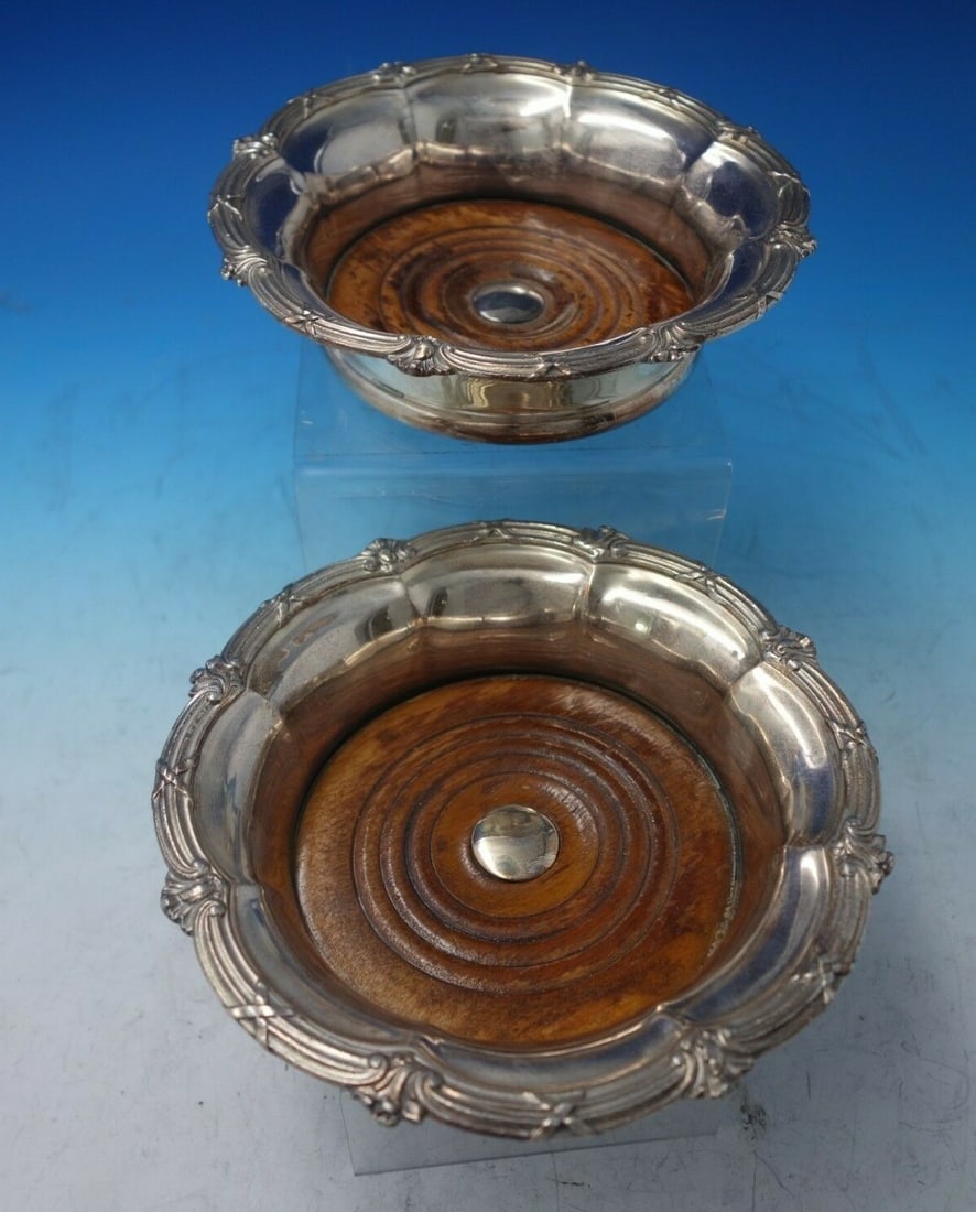 Marie Antoinette Silverplate Wood Champagne Coaster Pair: Marie Antoinette Silverplate Wood Champagne Coaster Pair This exquisite pair of champagne coasters features a stunning Marie Antoinette pattern, crafted from silverplate with a charming wood base. Eac