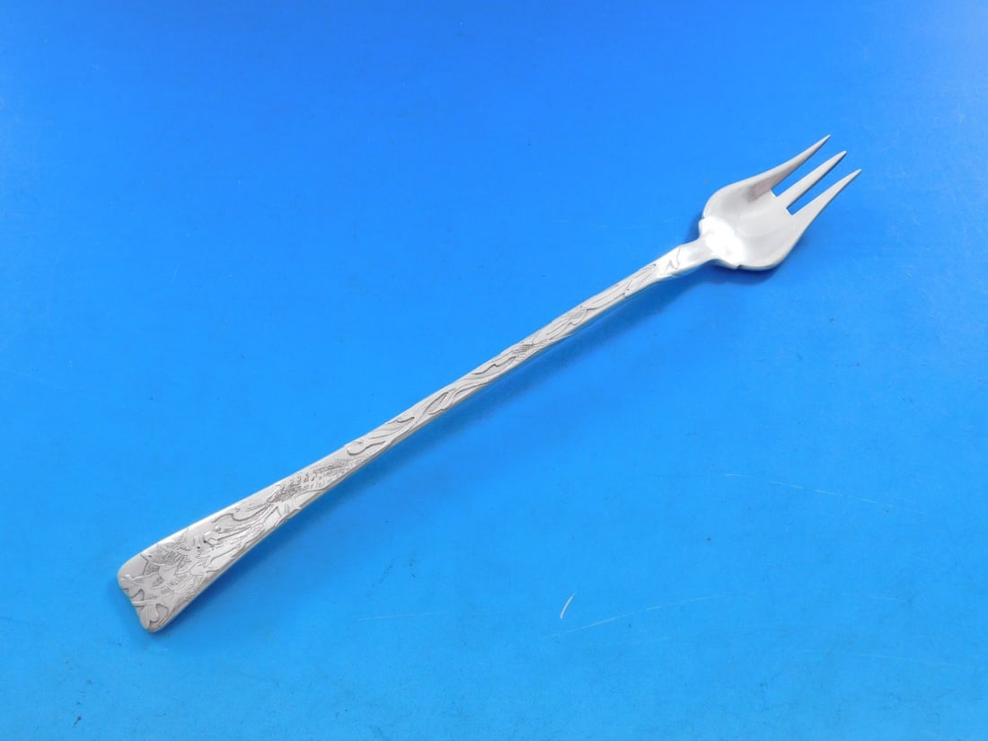 Tiffany & Co. Lap Over Edge Sterling Silver Cocktail Fork 6 1/8": Tiffany & Co. Lap Over Edge Sterling Silver Cocktail Fork 6 1/8" This exquisite cocktail fork, crafted by Tiffany & Co., features the elegant Lap Over Edge Acid Etched pattern. Measuring 6 1/8