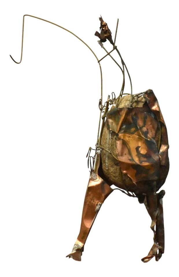Vintage Brutalist Fisherman Sculpture Copper Wire Art: Vintage Brutalist Fisherman Sculpture Copper Wire Art This striking Brutalist Fishing Sculpture captures the essence of a fisherman, expertly sculpted from wire wrapped around a rock. The use of layer