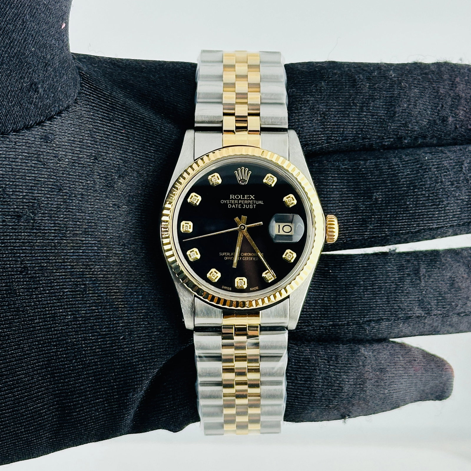 AM Black Diamond Dial Rolex Datejust Ref 16013 on Aftermarket Jubilee Bracelet: AM Black Diamond Dial Rolex Datejust Ref 16013 on Aftermarket Jubilee Bracelet This Rolex Datejust features a black diamond dial and a fluted bezel, complemented by an aftermarket Jubilee bracelet. Th