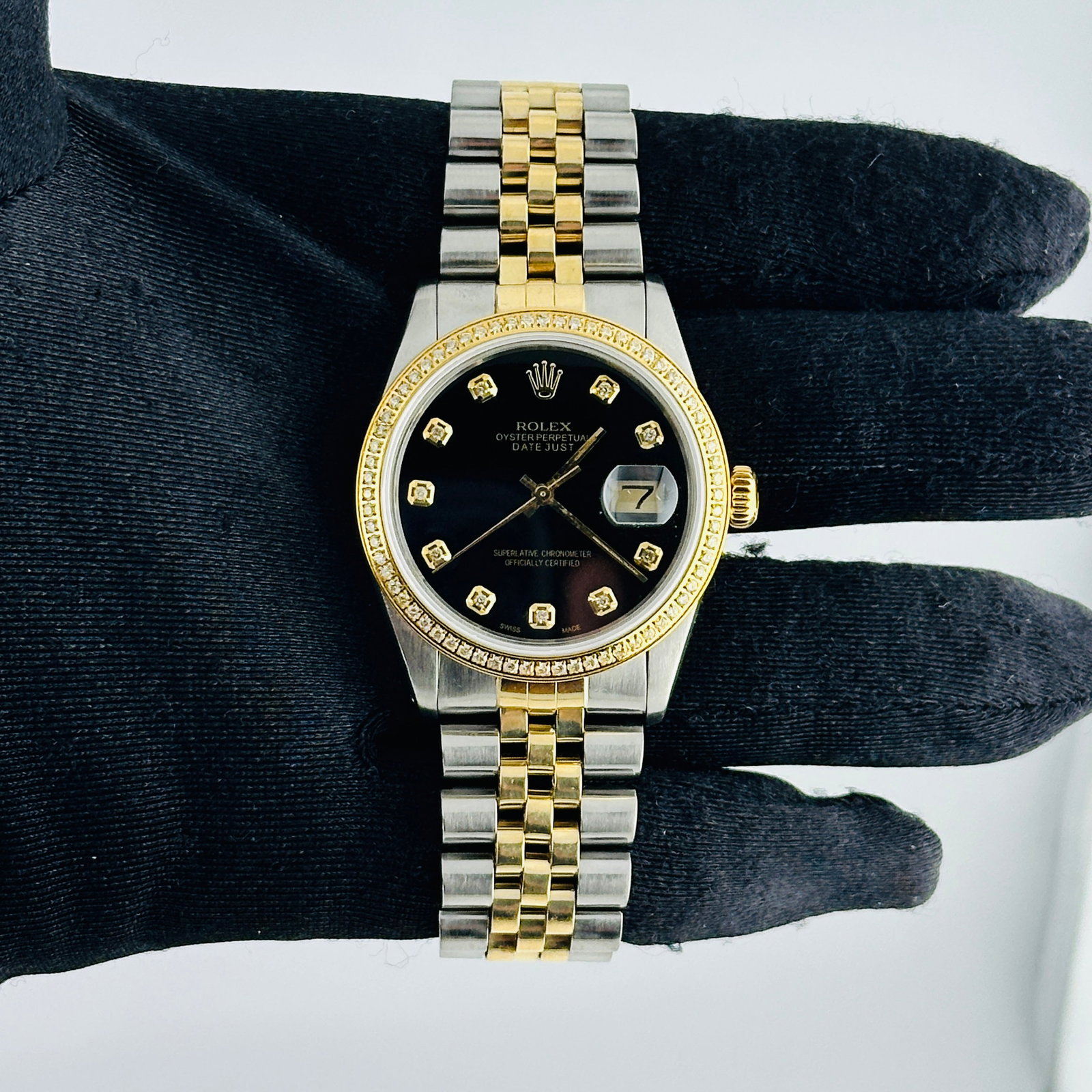 Aftermarket Black Diamond Dial D-Link Jubilee Rolex Datejust Ref 16013: Aftermarket Black Diamond Dial D-Link Jubilee Rolex Datejust Ref 16013 This Rolex Datejust watch features an aftermarket black diamond dial and a pave plated diamond bezel. It is equipped with a D-Lin