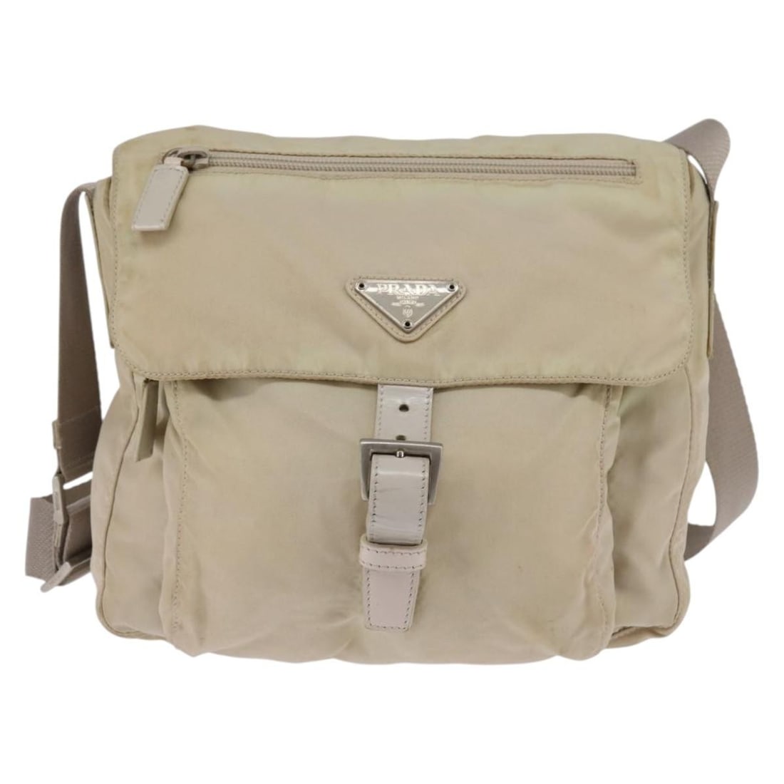 Beige Nylon Prada Messenger Bag with Buckle 24cm by 22cm by 8cm: Beige Nylon Prada Messenger Bag with Buckle 24cm by 22cm by 8cm This pre-owned Prada Buckle Messenger Bag features a unisex design in beige nylon with a shoulder strap. The bag exhibits signs of use i